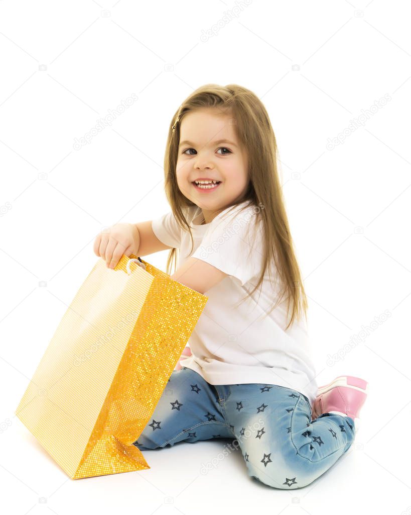 Little girl walks to the store with packages.