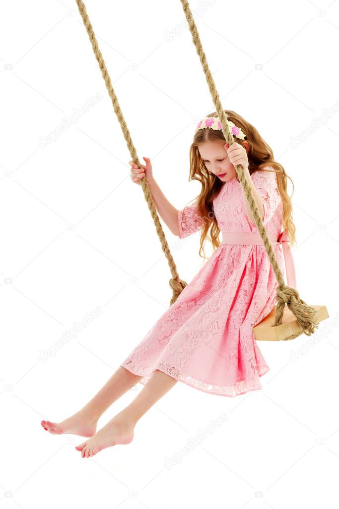 Little girl swinging on a swing