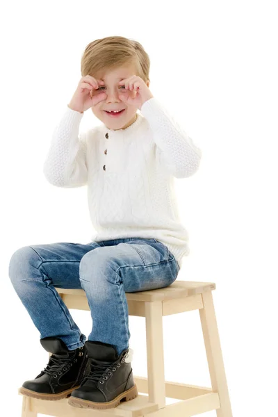 A little boy is sitting on a chair. — Stock Photo, Image