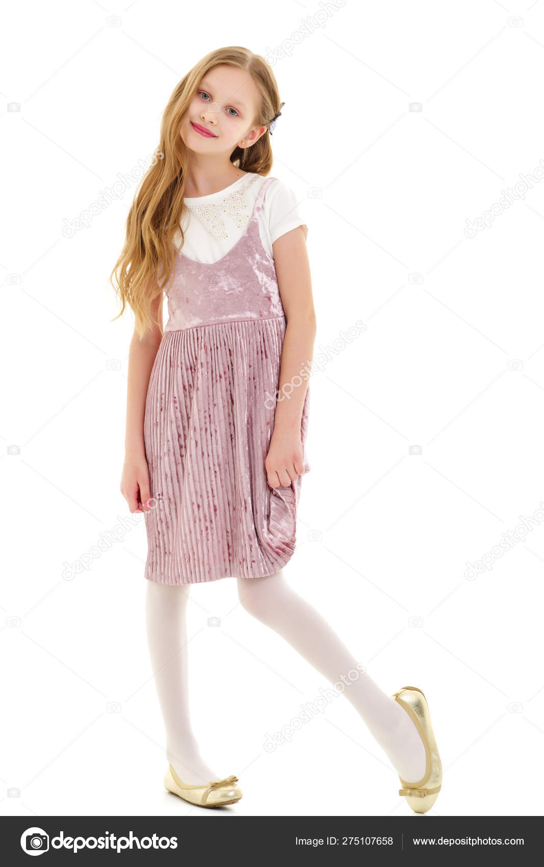 Beautiful little girl in an elegant dress in full growth. Stock Photo ...