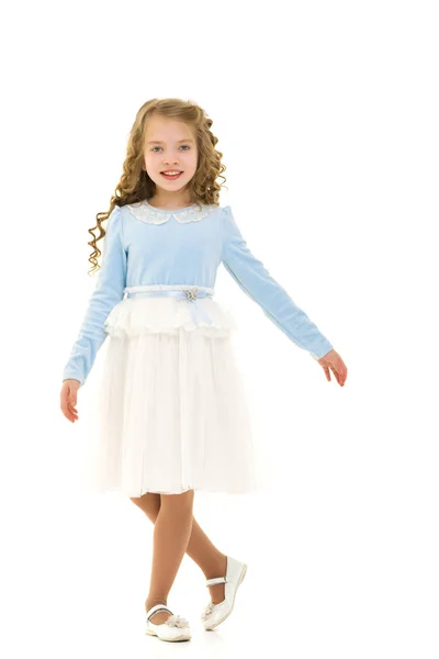 A little girl in a dress is spinning. — Stock Photo, Image