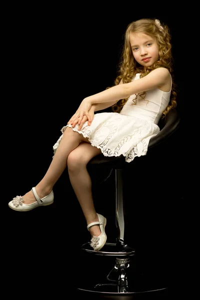 Маленька дівчинка сидить на стільці — стокове фото