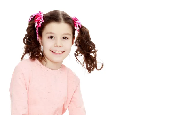 Little girl sitting on the floor and straightens hair. — Stock Photo, Image