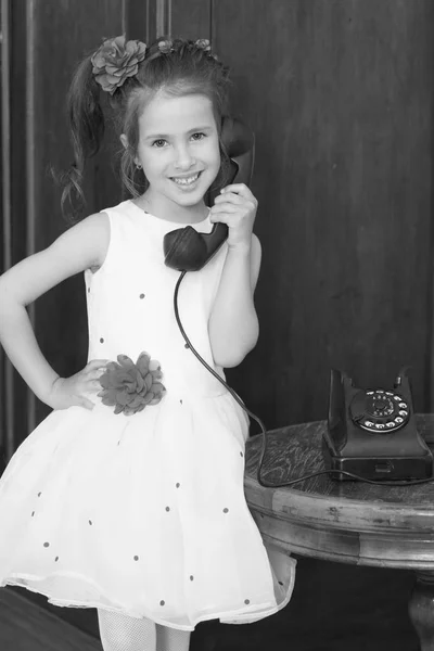 Menina com telefone vintage. Menina segurando a orelha até o telefone antigo — Fotografia de Stock