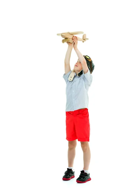 Мальчик играет с деревянным самолетом — стоковое фото