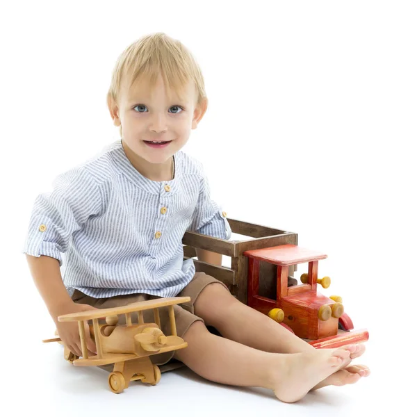 Küçük çocuk tahta uçakla oynuyor. — Stok fotoğraf