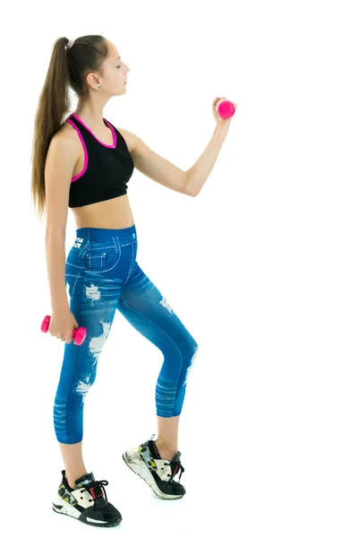 Teenage girl with dumbbells in hands — Stock Photo, Image