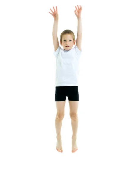 A little boy in a clean white T-shirt is jumping fun. — Stock Photo, Image