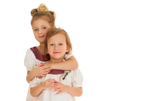 Sisters in matching dresses. Isolated on white background — Stock Photo, Image