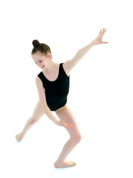 Little girl gymnast in a sports swimsuit. — Stock Photo, Image