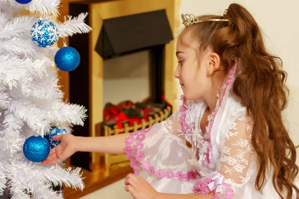 Küçük bir kız bir Noel ağacı süsleme. — Stok fotoğraf