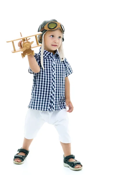 Little boy playing with wooden plane — Stock Photo, Image