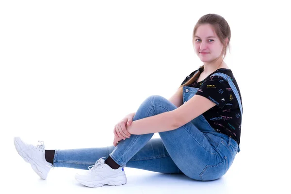 Teen girl posing on the floor in the studio. The concept of styl — Stock Photo, Image