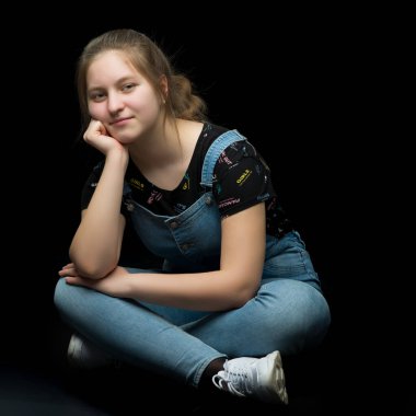 Stüdyoda yerde poz veren genç kız. Stil kavramı