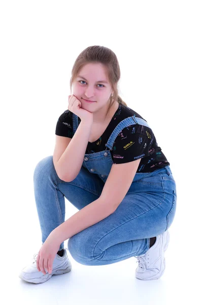 Teen girl posing on the floor in the studio. The concept of styl — Stock Photo, Image