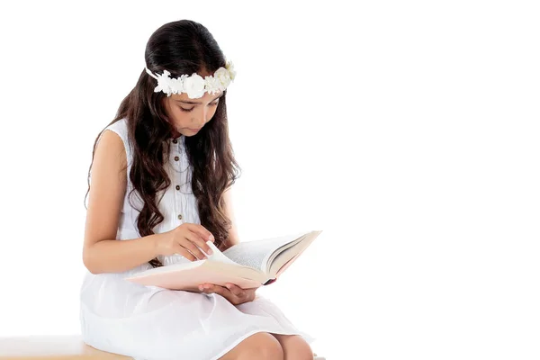 Kitaplı küçük bir kız. Beyaz arka planda izole edilmiş. — Stok fotoğraf
