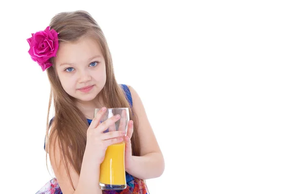 Porträt eines glücklichen kleinen Mädchens, das Orangensaft trinkt — Stockfoto