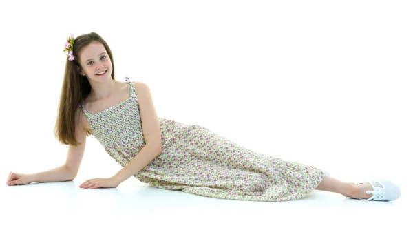 Teen girl lies in the studio on a white background. — Stock Photo, Image