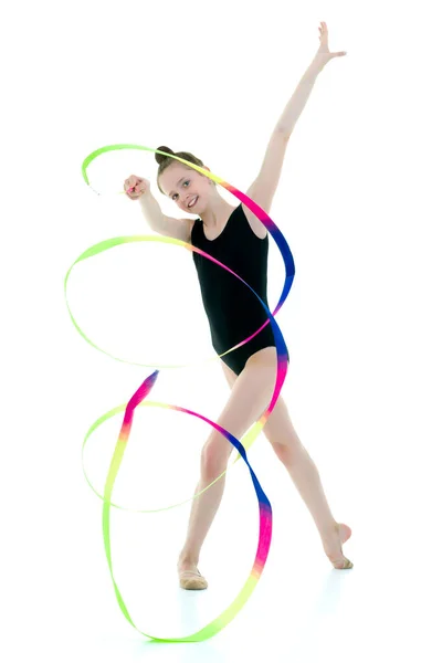 Girl gymnast performs exercises with tape. — Stock Photo, Image