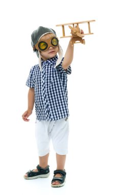Little boy playing with wooden plane clipart
