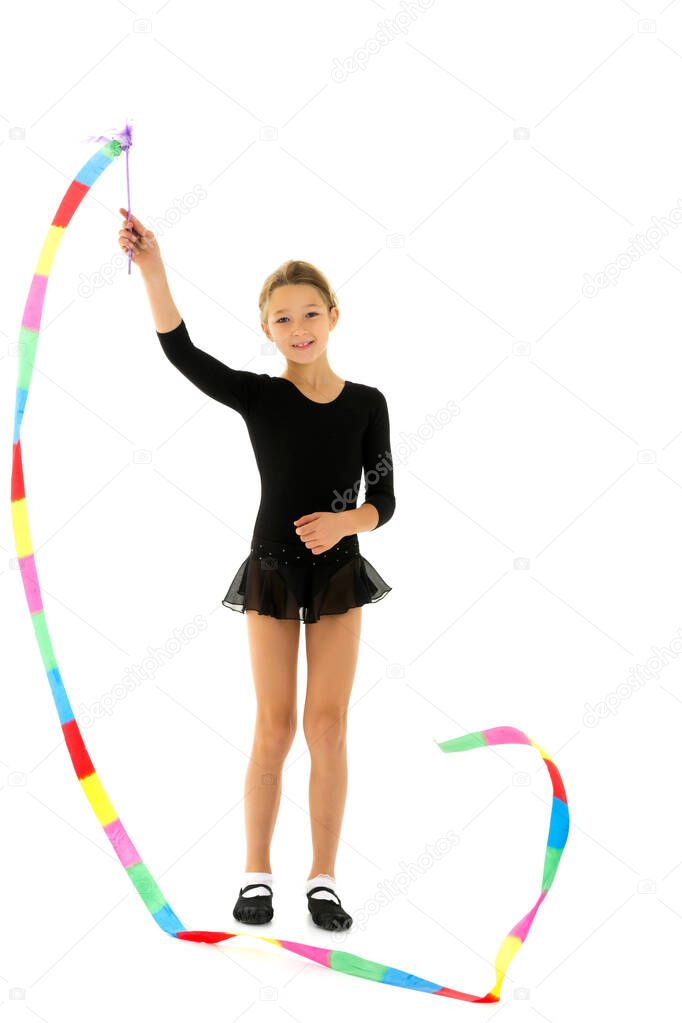Girl gymnast performs exercises with tape.