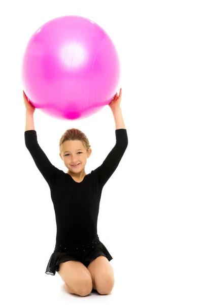 Little girl doing exercises on a big ball for fitness. — Stock Photo, Image