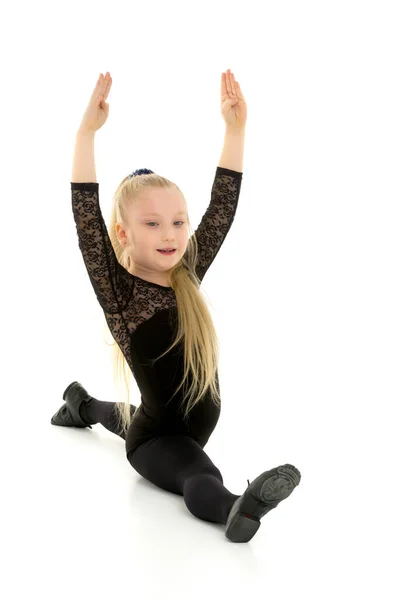 Schlanke Turnerin beim Binden. Das Konzept des Kindersports. — Stockfoto