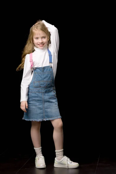 Little girl in a short denim dress. — Stock Photo, Image