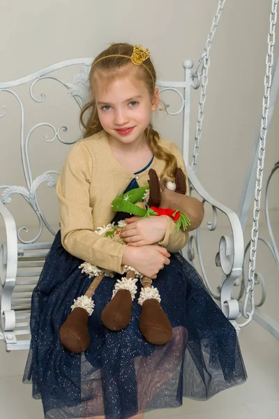 Schattig klein meisje spelen met een pop. — Stockfoto