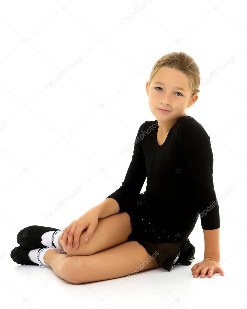 Cute little girl gymnast getting ready to perform a difficult exercise.