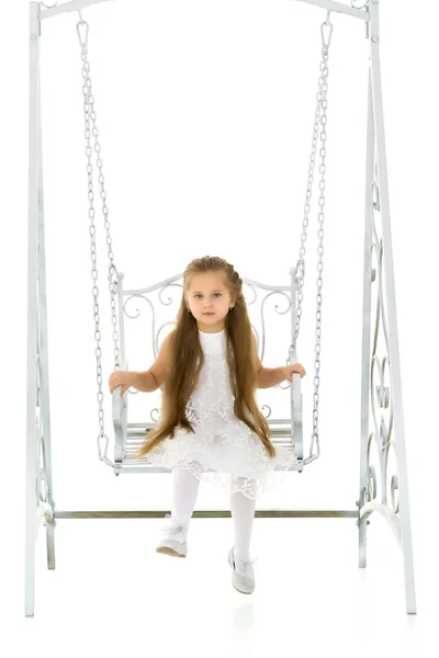 Gelukkig klein meisje schoolmeisje swinging op een swing. — Stockfoto