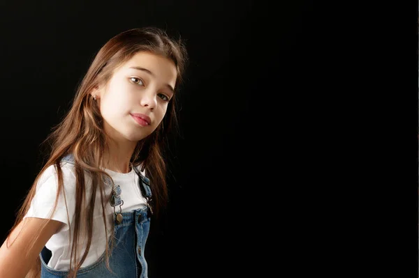 Little girl in denim clothes on a black background. — Stock Photo, Image
