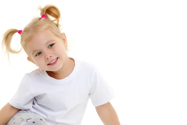 A little girl in a pure white T-shirt. Stock Picture