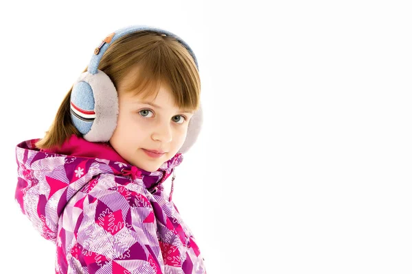 Egy kislány fülhallgatóval zenét hallgat.. Stock Fotó