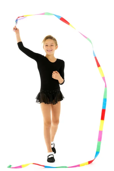 Girl gymnast performs exercises with tape. — Stock Photo, Image