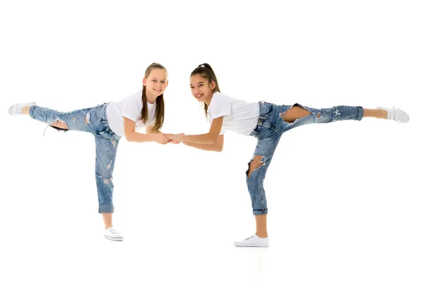 Dos niñas se toman de la mano, sobre un fondo negro. —  Fotos de Stock