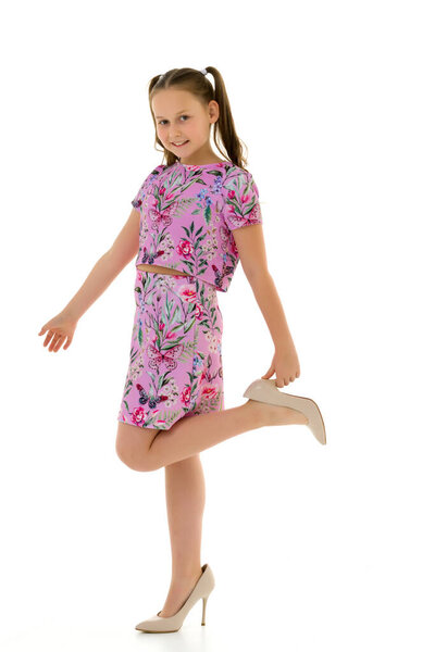 Cheerful little girl in large shoes taken from her mother.