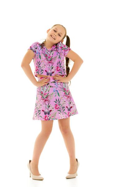 Cheerful little girl in large shoes taken from her mother.