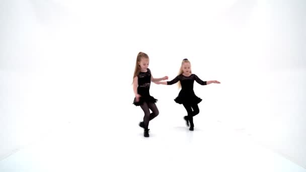 Twee vrolijke kleine meisjes dansen.. — Stockvideo