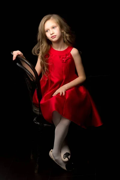 Front View Portrait of Adorable Girl in Stylish Dress Sitting on Chair. — Stock Photo, Image