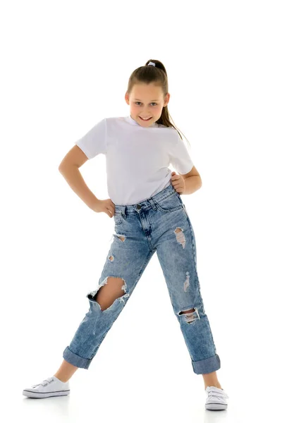 Beautiful teen girl in jeans with holes. — Stock Photo, Image