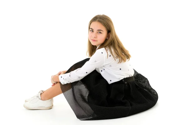 Κοριτσάκι που αγκαλιάζει τα γόνατα. καθισμένος στο πάτωμα. — Φωτογραφία Αρχείου