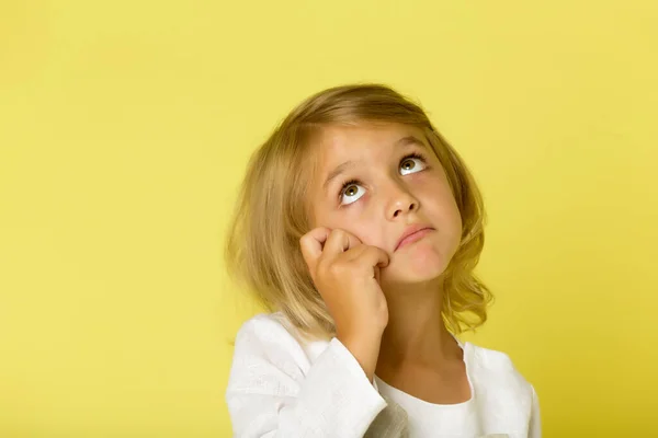 Het kleine meisje kijkt op.Het concept van kinderen emoties. — Stockfoto