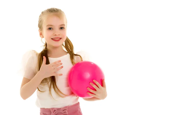 Little girl is engaged in fitness with a ball. — Stock Photo, Image