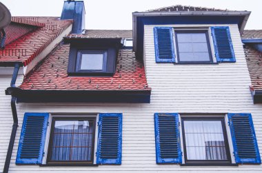 Mavi panjurlar ve kırmızı çatı Zona ile eski ahşap ev