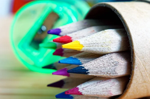 Crayons of wood with green pencil sharpener