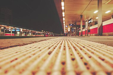 Demiryolu trafiği göstermek için yürüyen merdiven ve platform ve ışıklar ile gece Almanya 'da İstasyonu