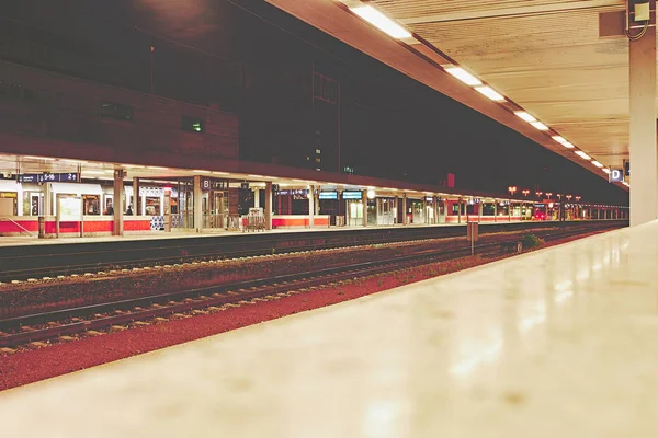 Demiryolu trafiği göstermek için yürüyen merdiven ve platform ve ışıklar ile gece Almanya 'da İstasyonu