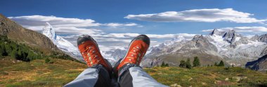 Swiss Alps with hiking boots in Zermatt area, Switzerland clipart