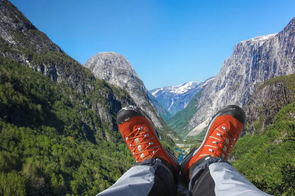 Deep valley with hiking boots close the Flam in Norway